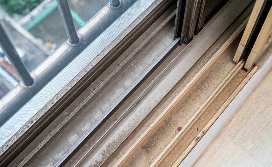 dirty dust piled up in plastic window frames.