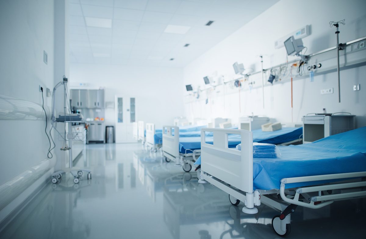 Close-up of empty hospital room with a bed.