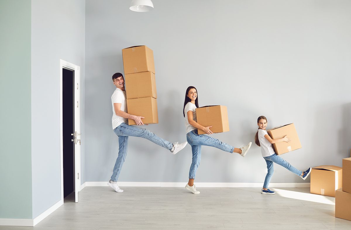 Family moving house home apartment relocation purchase rent mortgage sale room concept. A happy family is having fun playing with a box on the floor in a new apartment.